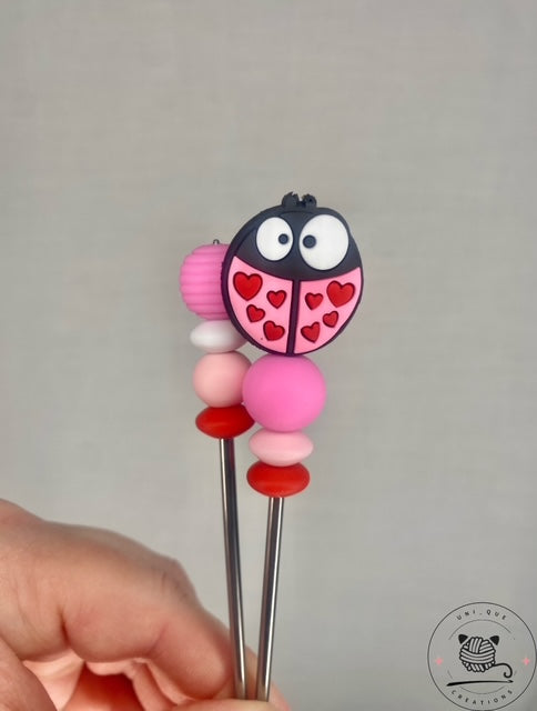 Pair of ladybird mini amigurumi sticks