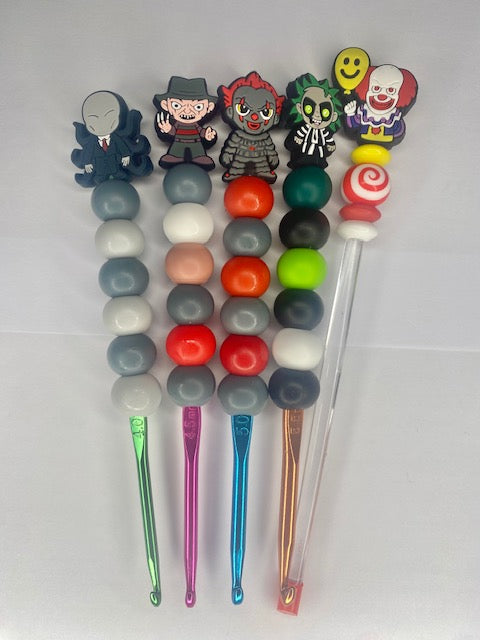 A set of 4 Spooky custom beaded crochet hooks and a stuffing stick