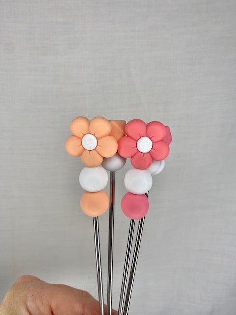 A pair of flower amigurumi sticks