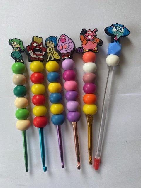 A set of  5 inside out custom beaded crochet hooks and a stuffing stick