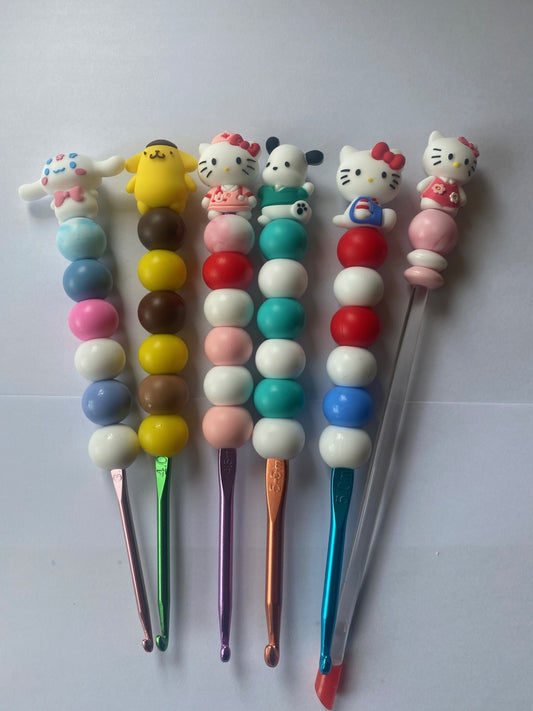 A set of 5 hello kitty custom beaded crochet hooks and a stuffing stick